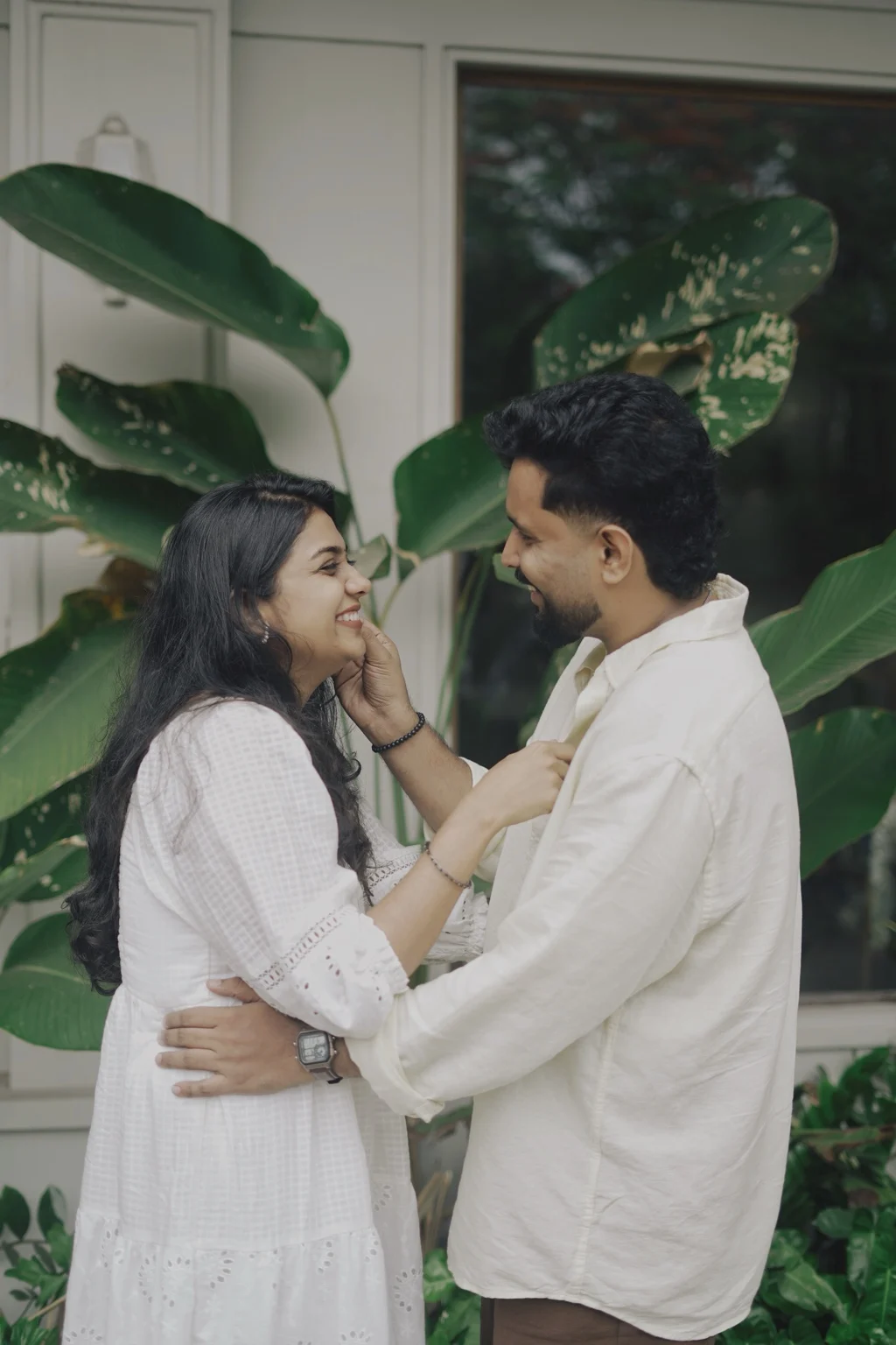 Abhilash and Induparvathi smiling together among green leaves